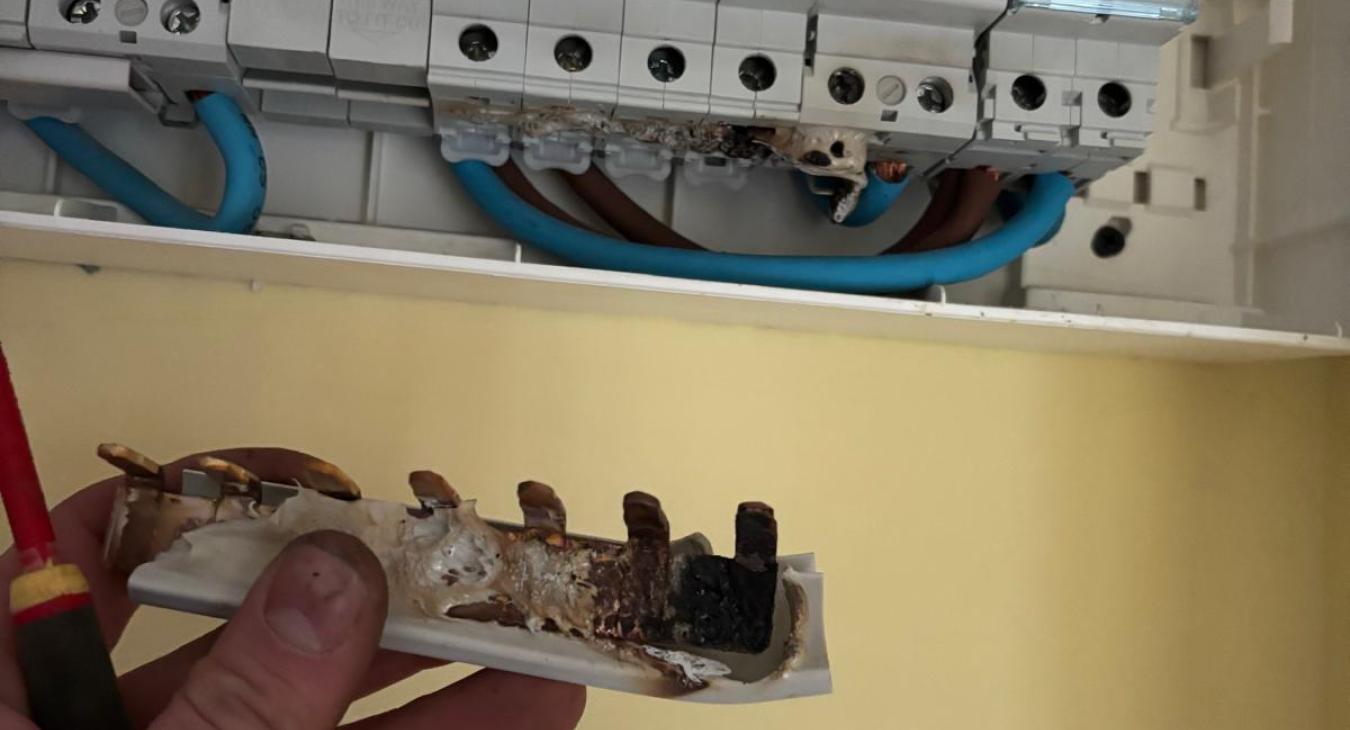 Damaged dual RCD consumer unit with overheating caused by loose shower circuit in Darlington