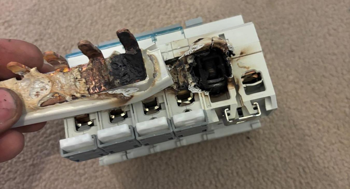Melted consumer unit busbar caused by loose shower connection in Darlington property
